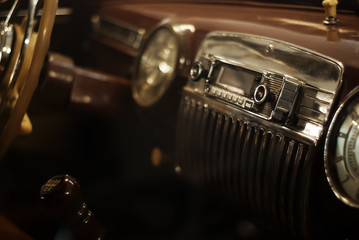 Blurred warm background - a fragment of the interior of a vintage car, focus on the handle of the...