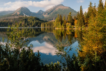 Beautiful mountain lake, autumn forest reflection in the water,