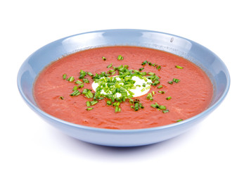 Beetroot cream soup decorated with yogurt and chives