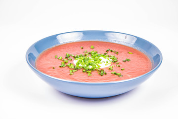 Beetroot cream soup decorated with yogurt mixed and chives