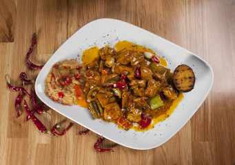 chicken fajitas on serving plate with hot peppers