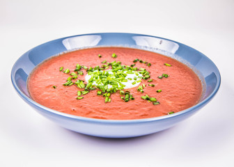 Beetroot cream soup decorated with yogurt and chives