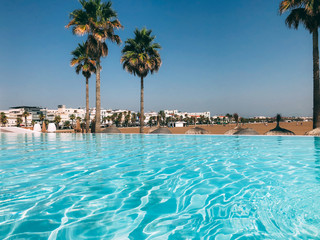 Fototapeta na wymiar Luxury swimming pool on the beach
