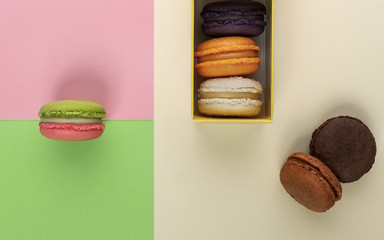 French macarons box on geometric colorful background