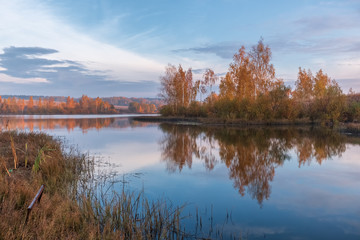 beautiful autumn landscape with a view of the lake at dawn