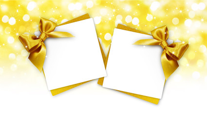 gift cards with golden ribbon bow Isolated on golden blurred lights christmas background