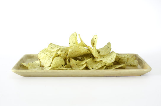 fried cripy potato on wood plate on white background, clipping path