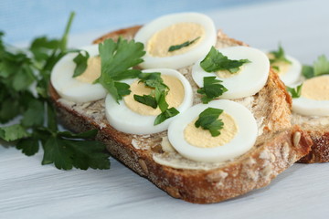 Sandwich with boiled egg and parsley.