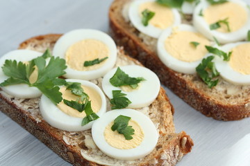 Sandwich with boiled egg and parsley.