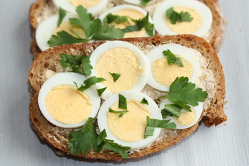 Sandwich with boiled egg and parsley.