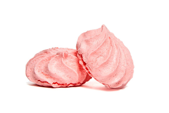 Two Meringue Cookies. Meringues Kisses In Pink Color. Airy And Practically Weightless Biscuits Based On Egg Whites And Powdered Sugar. Isolated On White Background