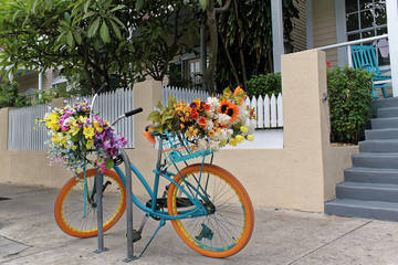 Fototapeta na wymiar Key West, Florida, USA - July 21, 2016: Bike with flowers in Duval St in Key West