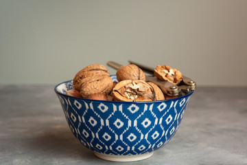 Healthy walnuts in a ceramic bowl.