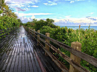 Fototapeta na wymiar Miami beach, Florida, USA - July 16, 2016: Famous wooden walkway in Miami beach