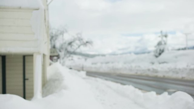 An empty icy road with large snow mounds for background plate