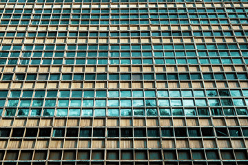 Many windows on facade of high-rise building Abstract pattern.