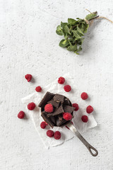 Naklejka na ściany i meble Chocolate with red chilli peppers, mint and raspberries
