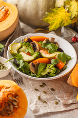 Autumn salad from baked pumpkin, beet, zucchini and carrots. Healthy vegan food concept.