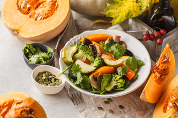 Autumn salad from baked pumpkin, beet, zucchini and carrots. Healthy vegan food concept.