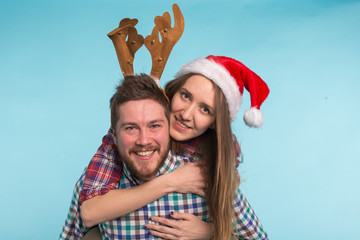 Couple wearing christmas costumes on blue background