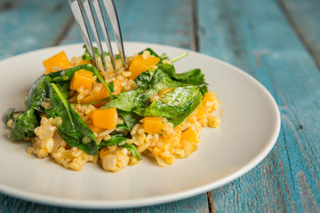 Vegan plate with bulgur and pumpkin.