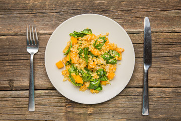Vegan plate with bulgur and pumpkin.