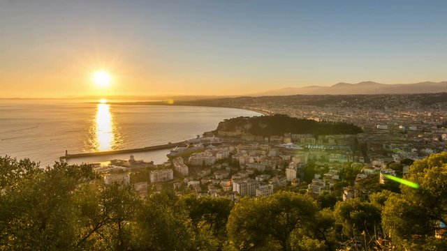 Sunset, city skyline and Mediterranean Sea scape. Panoramic view from Mont Baron towards the Port of Nice, southeast France. Time lapse video.