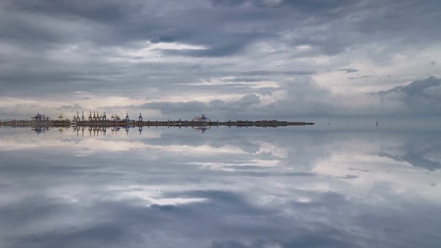 Commercial port, cloudscape and reflection