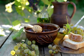 Still life with honey, grapes and white bread