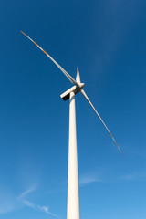 Wind turbine against blue sky. Wind energy. Eco concept.