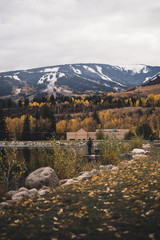 A man fishing at Nottingham Lake in Avon, Colorado with Beaver Creek in the background. 