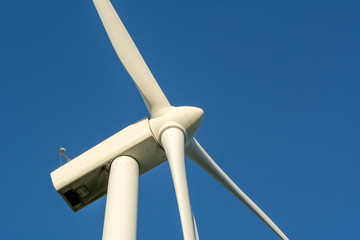 Wind turbine against blue sky. Wind energy. Eco concept.