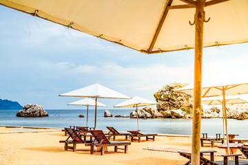 Beach umbrellas and sun beds on the sea coast