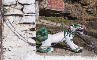 The figure of a fantastic dragon dog on the chain at the entrance to the Chagri Cheri Dorjeden...
