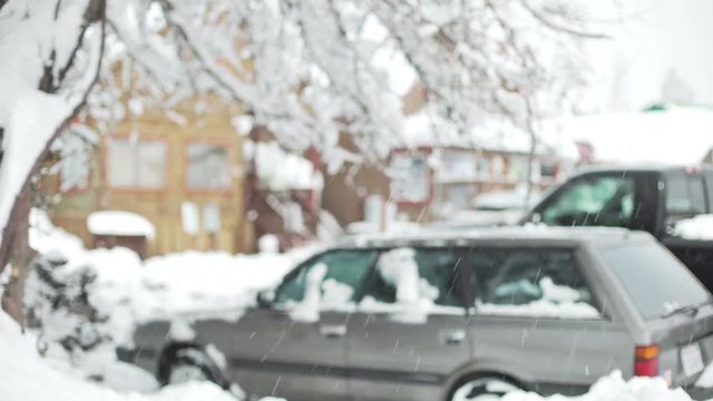 Snowy car parking lot near snow covered houses for background plate