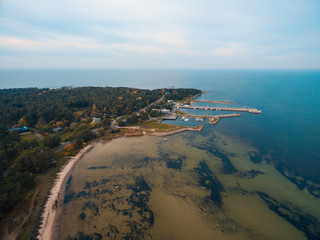 Obraz premium Top aerial view of the harbour for small vessels, both private and fishing boats in the Baltic Sea, Estonian coast