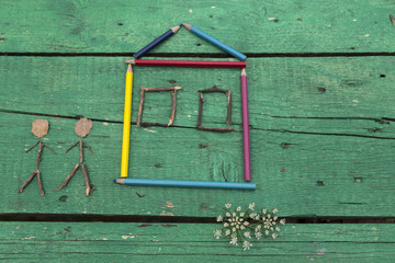 the child draw picture with colorful pens and flowers on the wooden green table in the nursery or school for activity concept. creative ideas for child development.back to school.