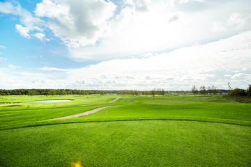 Rural environment with vast green field or valley, pathways, river and forest on background