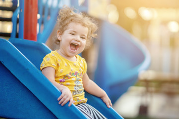 Little Toddler Playing At Playground Outdoors In Summer