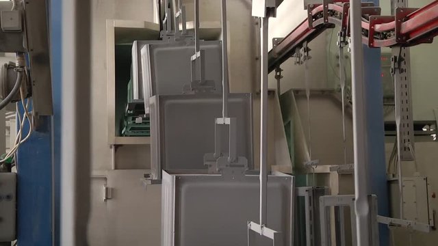 Automatic powder coating line. Powder coating of metal parts. Powder coating of metal parts with thermal polymerization paint.