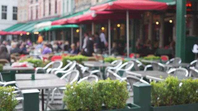 Out of focus background plate of row of European cafe patios for compositing
