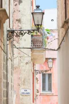Specchia, Apulia - Lanterns and a balcony in a historic alleyway