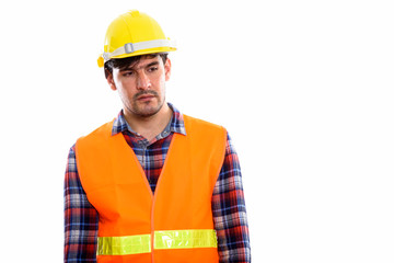 Young Persian man construction worker thinking while looking sad