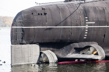 Ducks swim on the background of the engine of the Russian submarine