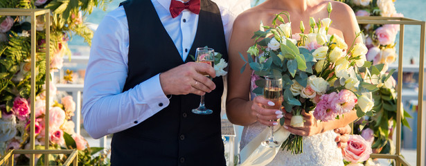 Bride and groom with champagne in their hands