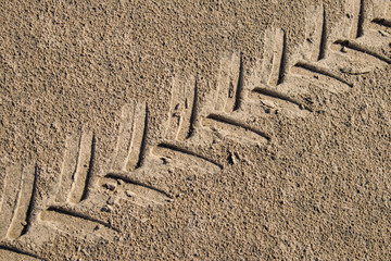Tire imprint on sand background