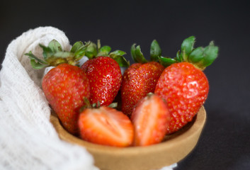 Strawberry on dark background with selective focus and crop fragment