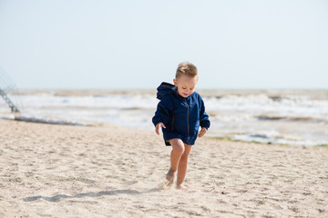 Baby boy run on the beach alone