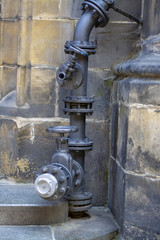 The complex element of the plumbing system outside the old building