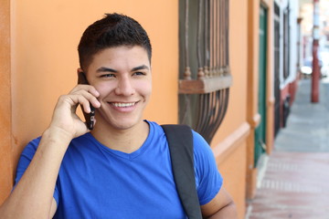 Young guy calling by phone outdoors